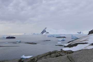 Antarctic landscape, bay with Icebergs ship and mountain, Antarctica
