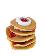 Stack of pancakes with sour cream and raspberry jam on white background