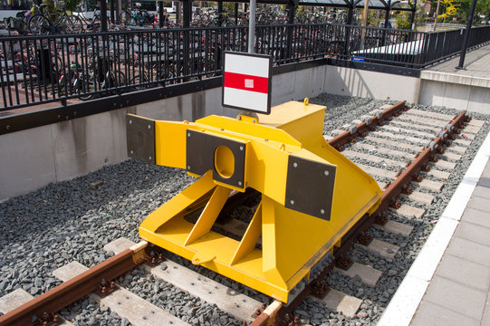 Closeup of yellow buffer stop of steel on railroad track