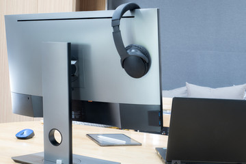 The extended monitor has the full size of the headphone on the top and there is a black notebook on...