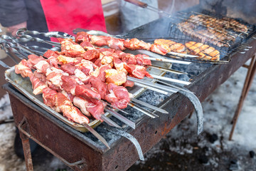 Grilled appetizing kebab cooking on metal skewers