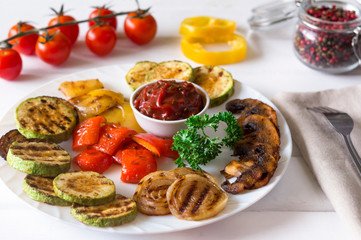 grilled vegetables served on a plate with tomato sauce