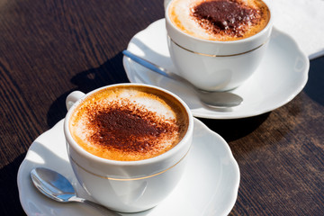 coffee in the morning, two cup of espresso on wood table in cafe or coffeeshop.