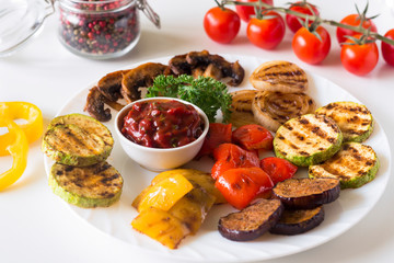 grilled vegetables served on a plate with tomato sauce