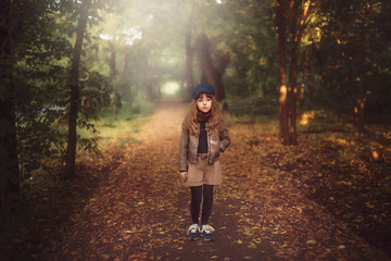 Fototapeta premium walking girl walks in autumn park alone