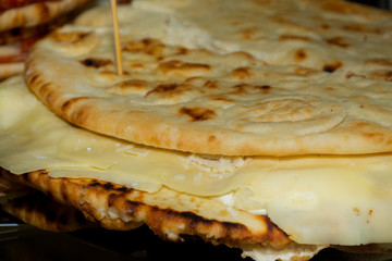 Pita with ham, cheese and salami display at the market. Italian street food