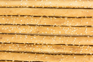 background of mediterranean grissini bread sticks with sesame