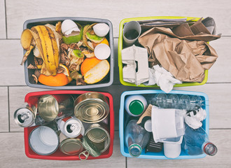 The four different container for sorting garbage. For plastic, paper, metal and organic waste
