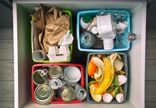 The four different container for sorting garbage. For plastic, paper, metal and organic waste