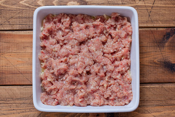 Step-by-step preparation of potato casserole with minced meat, step 4 - laying out the layer with minced meat, top view, selective focus