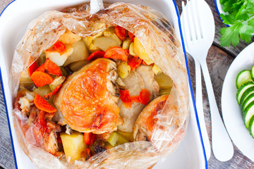 Baked chicken thighs with Brussels sprouts, potatoes, carrots, onions, selective focus