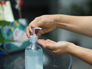 gel is dropping clear on the hands,women squeezing gel on finger the hand gel alcoholic 70 percent mixture with gelatin to prevent germs protect corona virus, covid19, hand Sanitizer