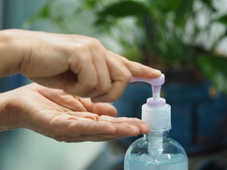 gel is dropping clear on the hands,women squeezing gel on finger the hand gel alcoholic 70 percent mixture with gelatin to prevent germs protect corona virus, covid19, hand Sanitizer