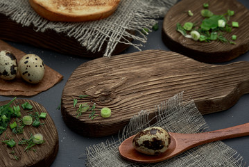 Rustic photo. On a wooden cutting Board, cut green onions and quail egg in a wooden spoon.