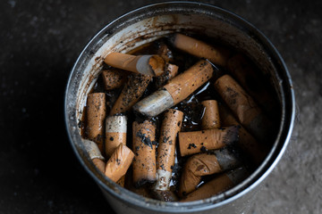 Cigarette butts in a makeshift can of drug addicts
