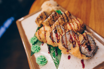 Large set of Sushi Rolls Warm Ebi Sake Unagi Spring. A lot assortment Philadelphia roll Dishes from Japanese raw fish  in one plate in traditional restaurant. Japan food menu service