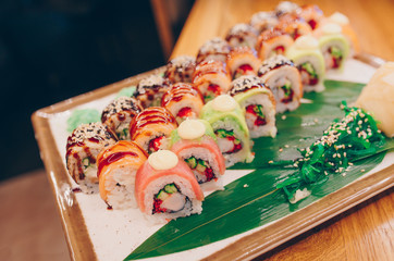 Large set of Delicious sushi rolls view from above Flat Lay . A lot assortment Philadelphia roll Dishes from Japanese raw fish  in one plate in traditional restaurant. Japan food menu service