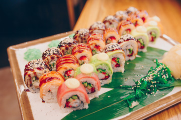 Large set of Delicious sushi rolls view from above Flat Lay . A lot assortment Philadelphia roll Dishes from Japanese raw fish  in one plate in traditional restaurant. Japan food menu service