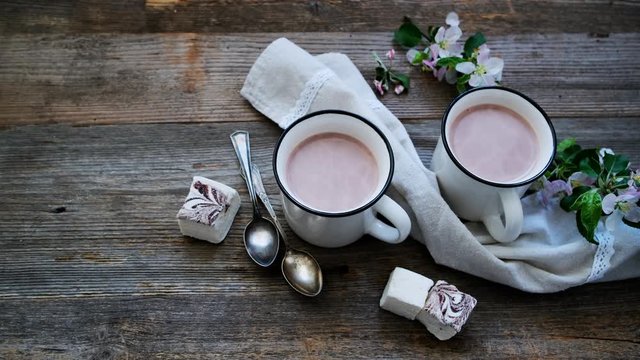 Cups with cocoa and pieces of marshmallow