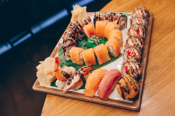 Large set of Delicious sushi rolls view from above Flat Lay . A lot assortment Philadelphia roll Dishes from Japanese raw fish  in one plate in traditional restaurant. Japan food menu service