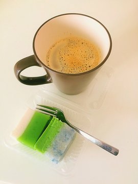 Close-up Of Coffee And Kuih Talam On Table