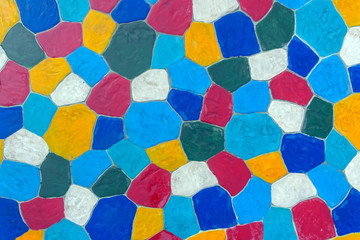 The walkway in the garden are paved with brightly colored stones and have just been cleaned by washing with water.