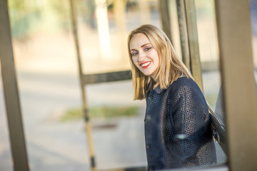 young woman sitting at the bus stop