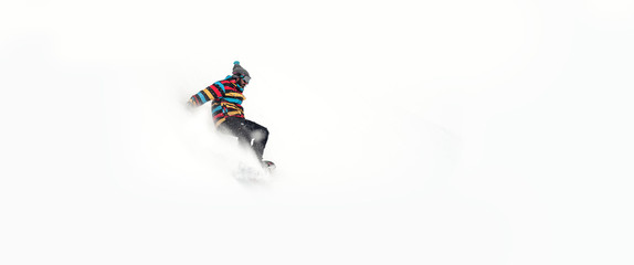 Freerider snowboarder rolls and rides his snowboard on extreme gradient downhill. Winter mountain...