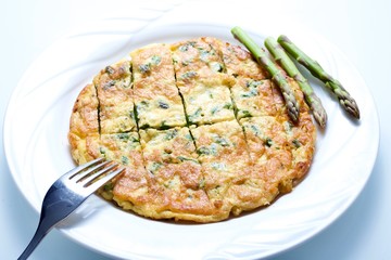 Omelette with asparagus in white background
