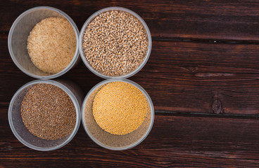 Raw porridge, food supplies in the kitchen. A variety of cereals in the food containers.