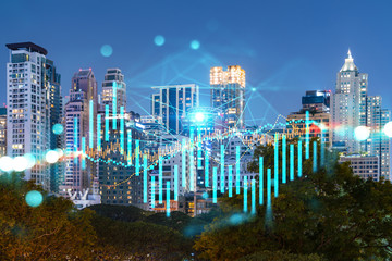 Night view cityscape of Bangkok city skyscrapers background with financial graph. Success and finance concept. Multiexposure