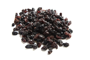 Raisins isolated on white background. Heap of dried red grapes
