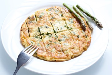 Omelette with asparagus in white background