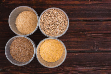 Raw porridge, food supplies in the kitchen. A variety of cereals in the food containers.