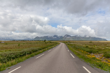 road passing in a valley between mountains in Norway, selective focus