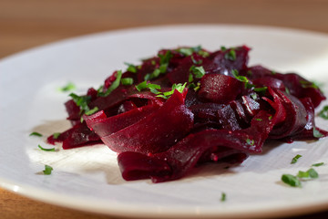 beetroot in a white plate on the wooden table