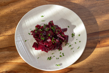 beetroot in a white plate on the wooden table