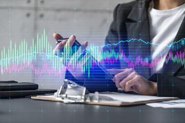 A woman using smartphone and forex chart. Concept of financial markets. Fintech. Formal wear....
