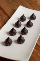 drop-shaped chocolates in a white plate