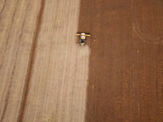 Aerial image of a combine harvester harvesting soybeans in brazil