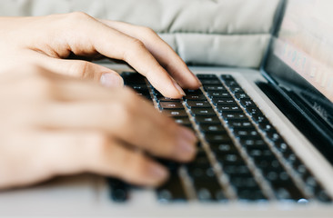 hands typing on a keyboard