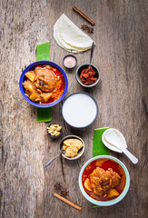 Top view Chicken Massaman with red Curry mixed with coconut milk serving with naan butter bread or roti, Traditional Thai local food or Asian cuisine