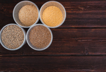 Raw porridge, food supplies in the kitchen. A variety of cereals in the food containers.