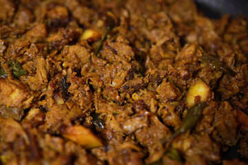 South Indian dish spicy beef fry Kerala, India. side dish ghee rice, appam, parotta, puttu, bread and chappathi, Kerala cuisine ,Buffalo roast / Meat pepper fry with coconut. India spices cooking,