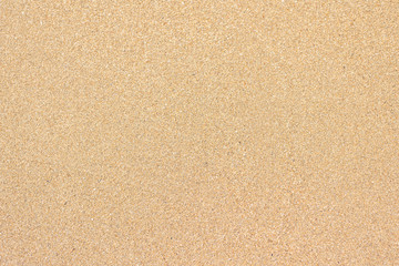 Fototapeta na wymiar Seamless wet yellow sand background on sunset beach. Close-up