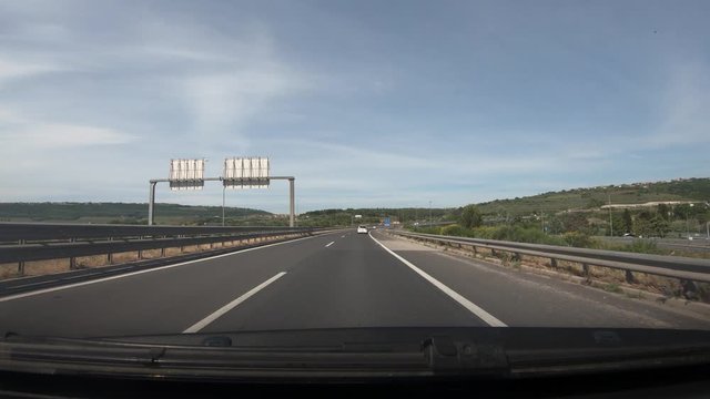 Dashboard point of view POV, driving on Slovenia highway. Dash cam view of asphalt road and karst landscape. Wide shot, forward dolly moving