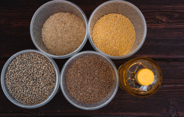 Various cereals and a bottle of sunflower oil. Raw porridge, food supplies in the kitchen.