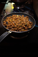 South Indian dish spicy beef fry Kerala, India. side dish ghee rice, appam, parotta, puttu, bread and chappathi, Kerala cuisine ,Buffalo roast / Meat pepper fry with coconut. India spices cooking,