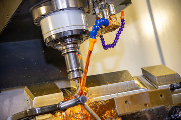The CNC milling machine cutting the tire mold parts with liquid oil coolant method. The mold and...