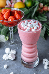 Raspberry smoothie with colored marshmallows and berries. Summer refreshing berry smoothie. smoothie with marshmallows and caramel sweets